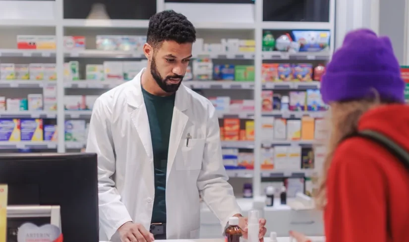 multiracial-pharmacist-selling-medications-to-youn-2024-10-19-22-04-13-utc